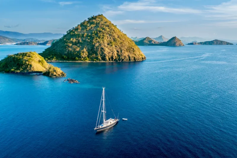 Aerial view of sailboat with island under blue sky in Labuan Bajo near Bali Island, Indonesia